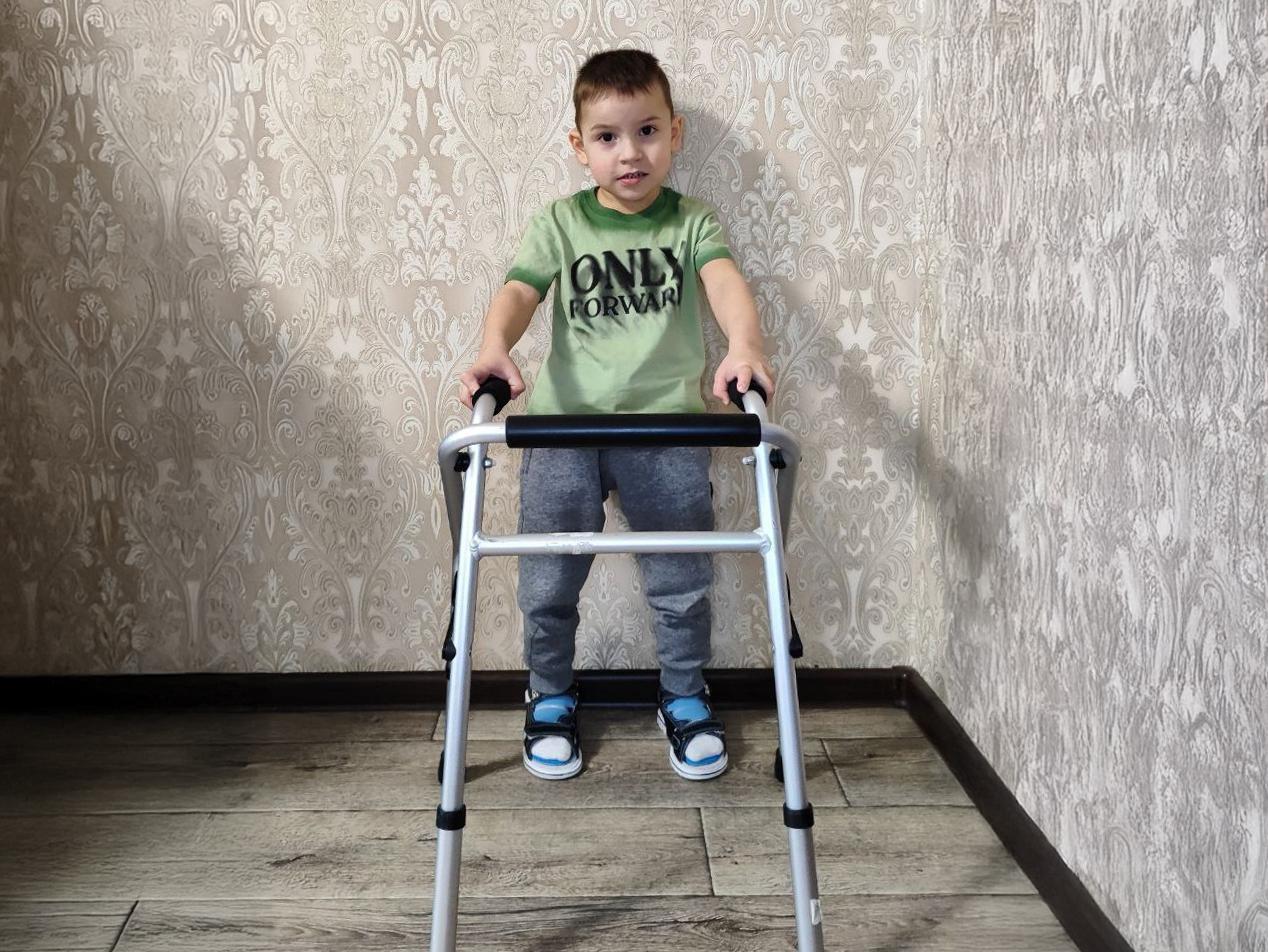 Rolan, a boy with cerebral palsy, needs help to get an active wheelchair