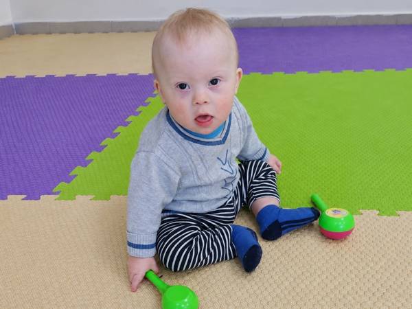 Vanya is an adopted child with Down syndrome. He needs rehabilitation to learn how to communicate!