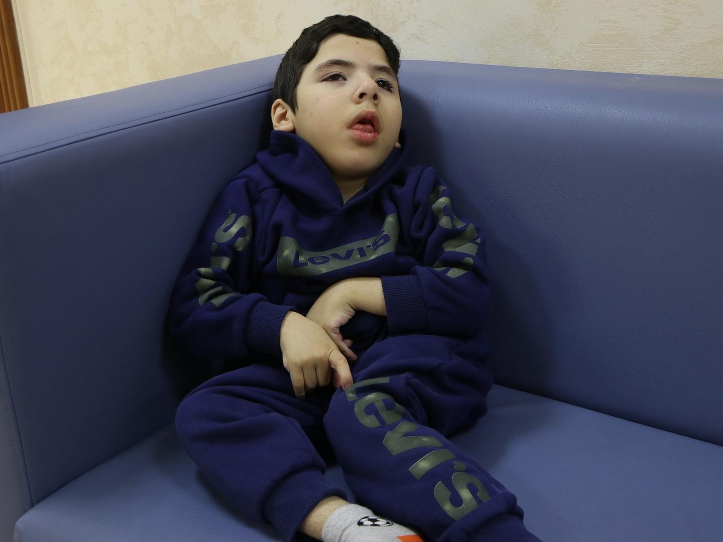 For Ali to learn to sit up independently and develop the swallowing reflex, he needs help from specialists